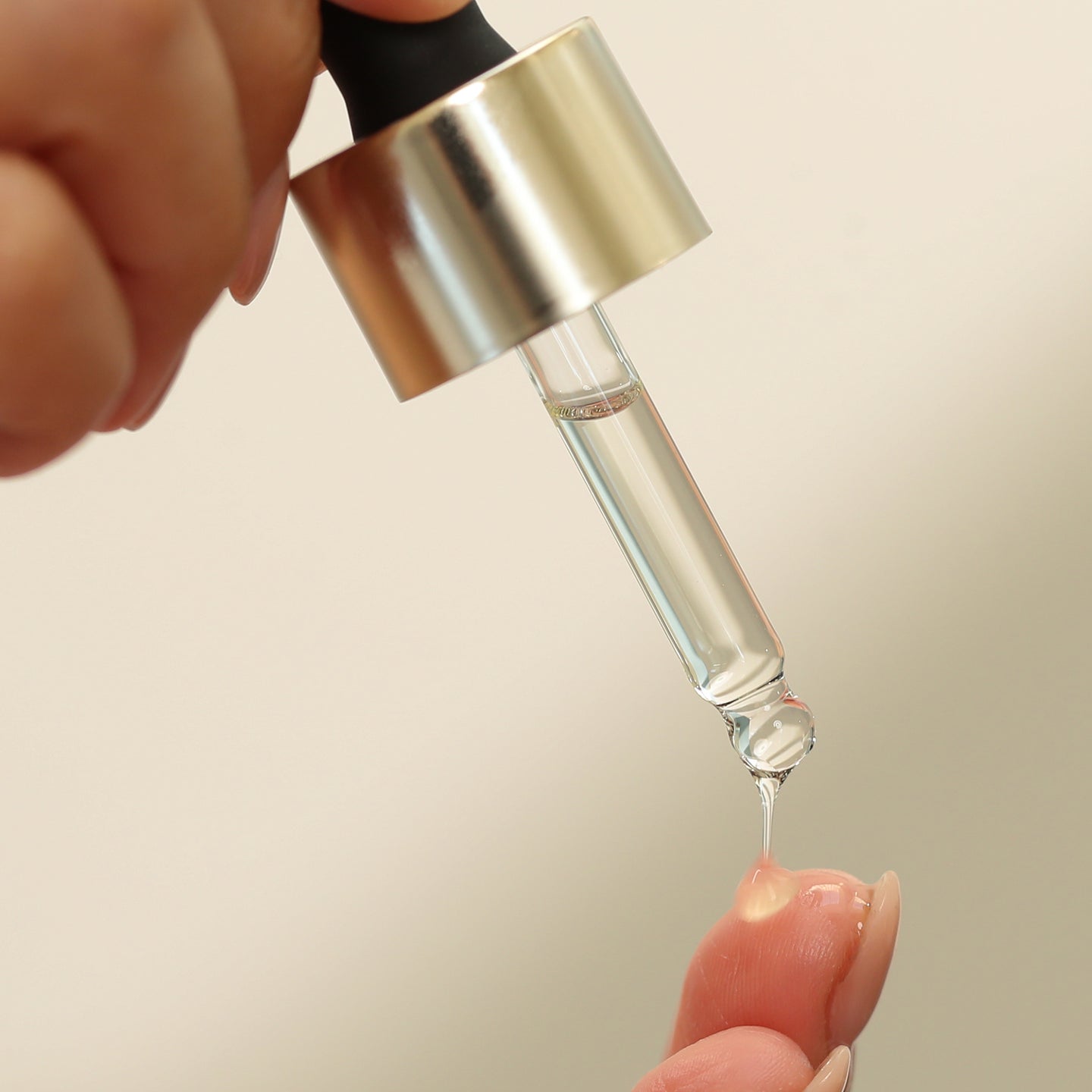 Image showing product applicator dropper putting product on fingers