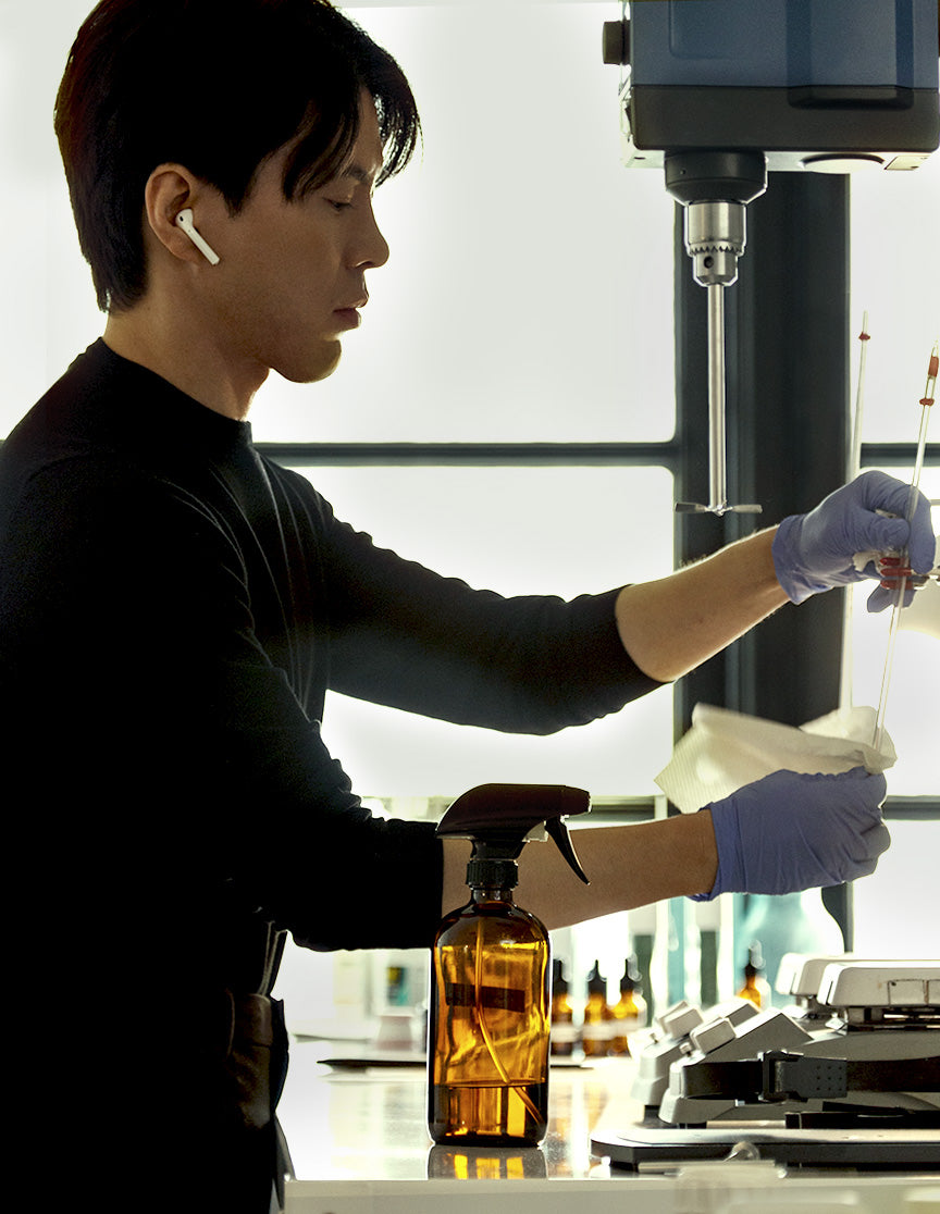 Image of MATTER OF FACT founder Paul Baek using instruments in product lab
